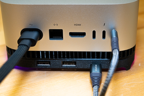 The back of a Mac mini on Blinkenhub, with two USB-A ports in the stand below the Mac's own ports